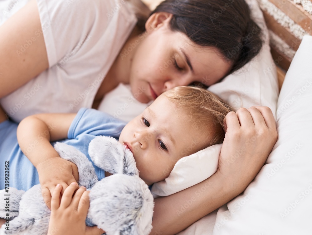 Mother and son sleeping on bed hugging doll at bedroom Mother and son sleeping on bed hugging doll at bedroom