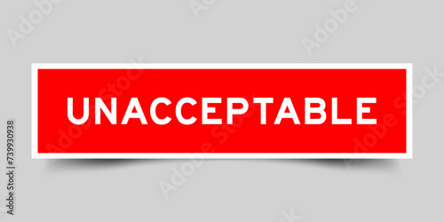 Square sticker label with word unacceptable  in red color on gray background