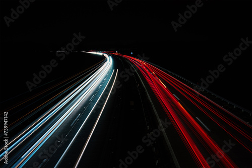 Light trails on the highway at night. Rush hour on motorway with glowing cars headlamps, long exposure