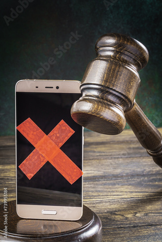 Judge gavel with a smartphone with a taped screen