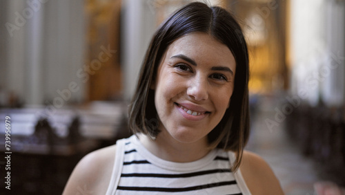 Young beautiful hispanic woman visiting church at Augustinian Church in Vienna