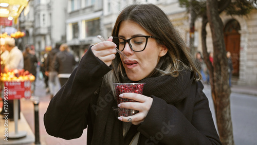 Photography Adult woman eating pomegranate in a bustling istanbul street market