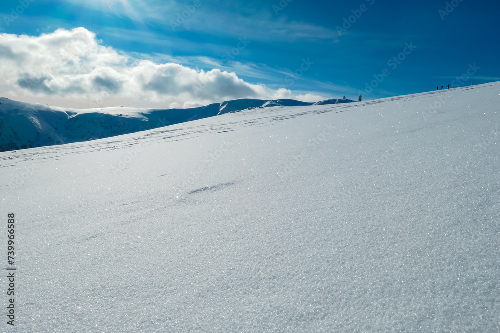 Idyllic snow covered alpine meadow with scenic view of majestic mountain peak Grosser Speikogel in Kor Alps, Lavanttal Alps, Carinthia Styria, Austria. Winter wonderland in Austrian Alps. Ski touring