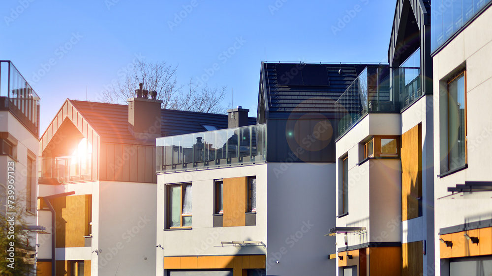New single family houses in a new development area. Residential homes with modern facade. New single family houses in a new development area. Residential homes with modern facade.