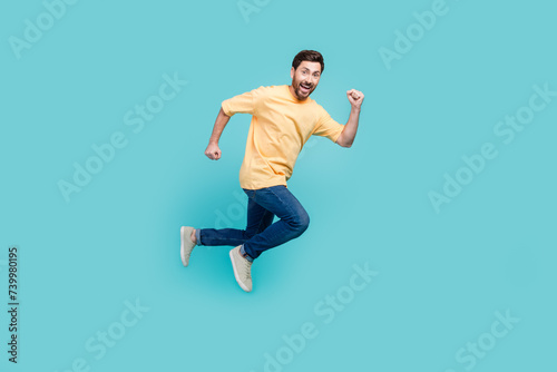 Full body length photo of active guy brunet boyfriend running away from his ex girlfriend home isolated on aquamarine color background photo