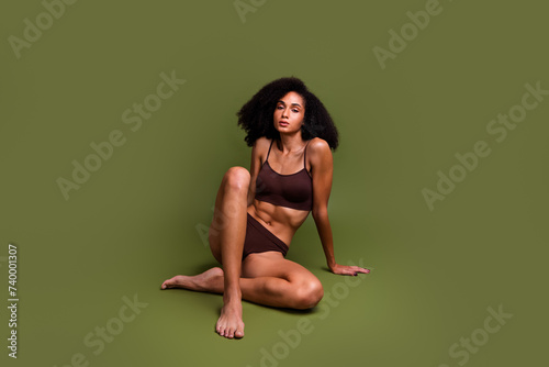 No filter photo of gorgeous sportive body girl strong athletic shape flawless perfect figure isolated over khaki color background