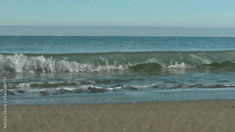 seascape in slow motion. waves with sun reflections and fine sand seascape in slow motion. waves with sun reflections and fine sand