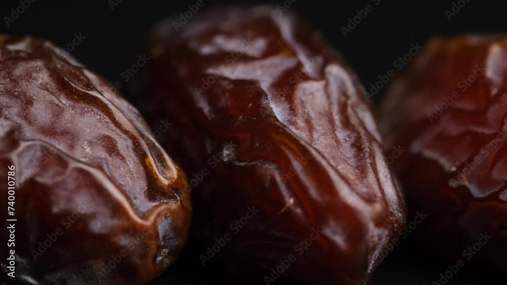 Dried dates, dried fruits on a black background close-up.