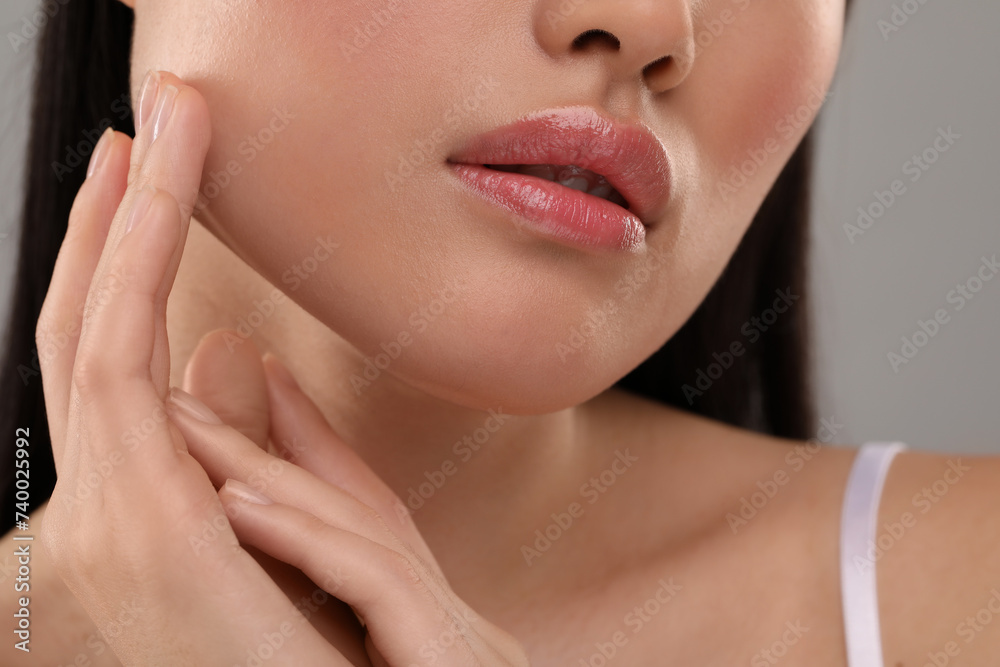 Beautiful woman with healthy skin on gray background, closeup Beautiful woman with healthy skin on gray background, closeup