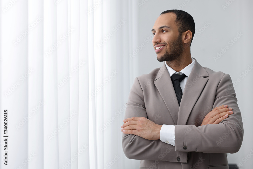 Portrait of smiling young man in office, space for text. Lawyer, businessman, accountant or manager Portrait of smiling young man in office, space for text. Lawyer, businessman, accountant or manager