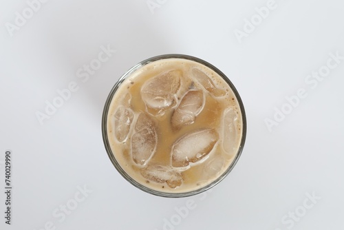 Iced coffee in glass on white background  top view