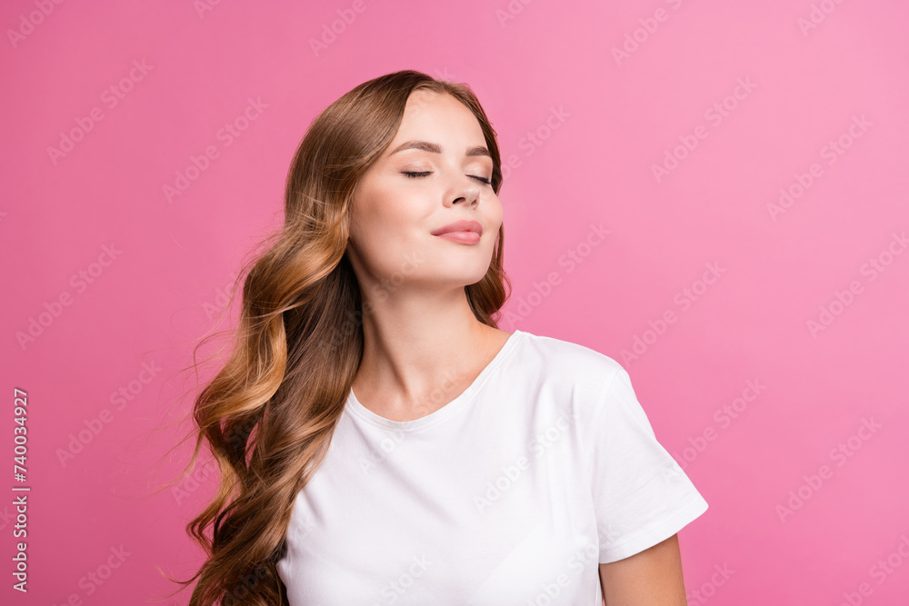 Portrait of peaceful girl with fluttering curly hair dressed white t-shirt close eyes enjoy wind blow isolated on pink color background Portrait of peaceful girl with fluttering curly hair dressed white t-shirt close eyes enjoy wind blow isolated on pink color background