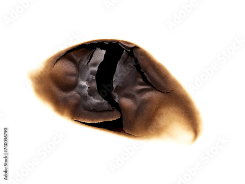 Burned hole in paper isolated on white background