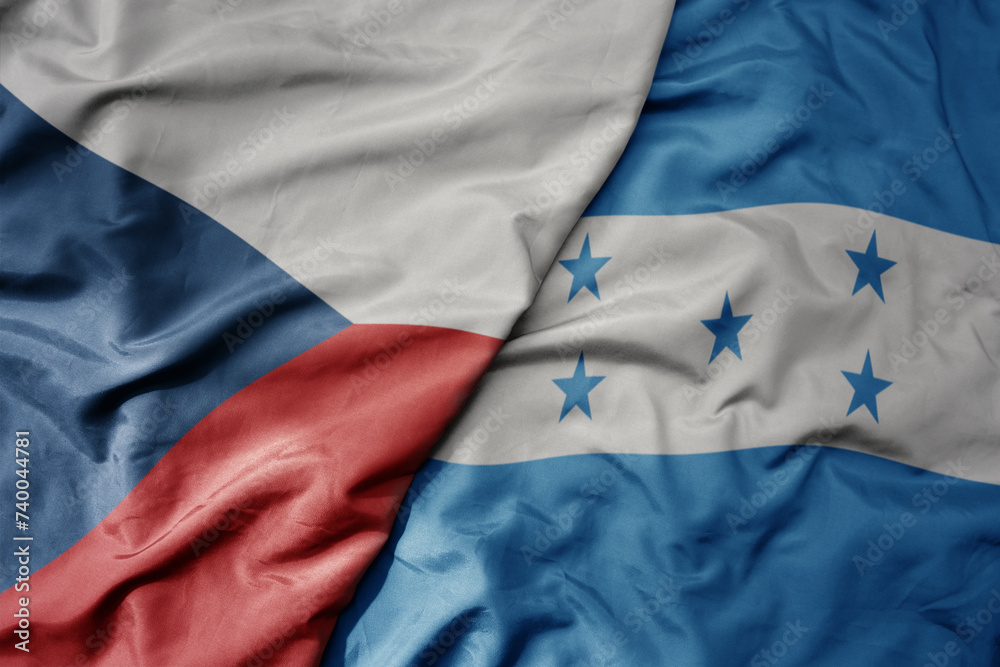 big waving national colorful flag of honduras and national flag of czech republic.
