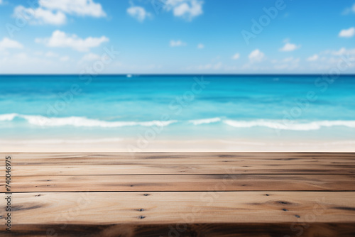 Wooden tabletop set against a blurred background of a blue sea and white sand beach.