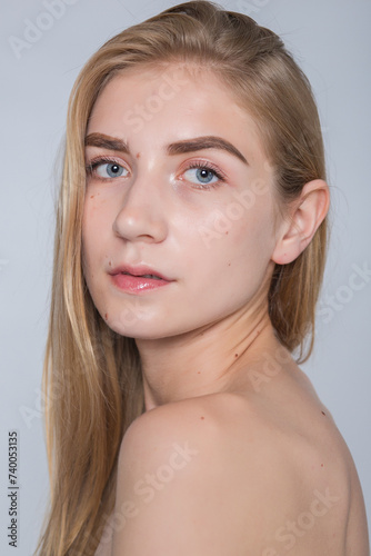 Effortless elegance meets pure beauty in this image of a young woman cherishing her flawless skin. Ideal for beauty product advertisements.