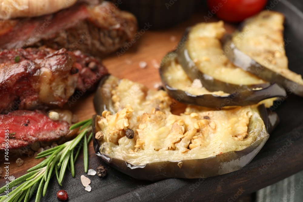 Delicious grilled eggplant and beef with spices on table, closeup Delicious grilled eggplant and beef with spices on table, closeup