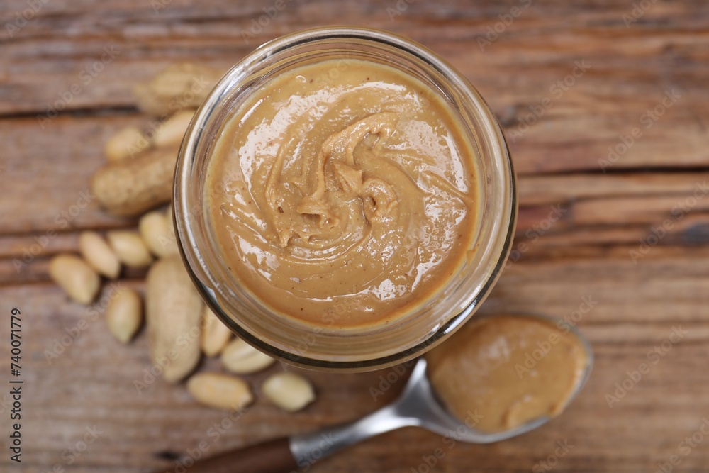Tasty peanut nut paste in jar on table, top view Tasty peanut nut paste in jar on table, top view