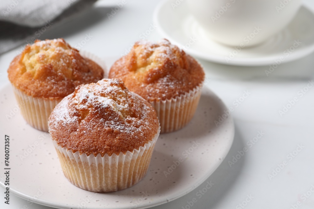 Delicious sweet muffins on white table, closeup. Space for text Delicious sweet muffins on white table, closeup. Space for text