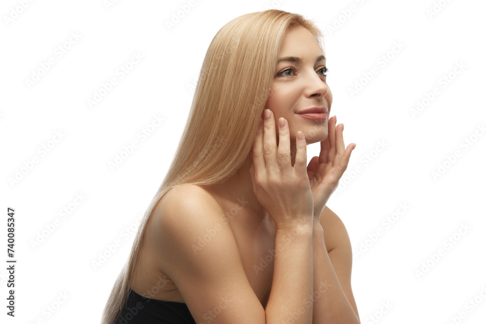 Woman with blonde hair touching her face gently, enjoying softness and elasticity of skin after treatments against white studio background. Concept of beauty, anti aging, cosmetology, female health. Woman with blonde hair touching her face gently, enjoying softness and elasticity of skin after treatments against white studio background. Concept of beauty, anti aging, cosmetology, female health.