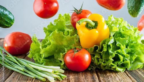 Falling vegetables, fresh salad of bell pepper, tomato and lettuce leaves