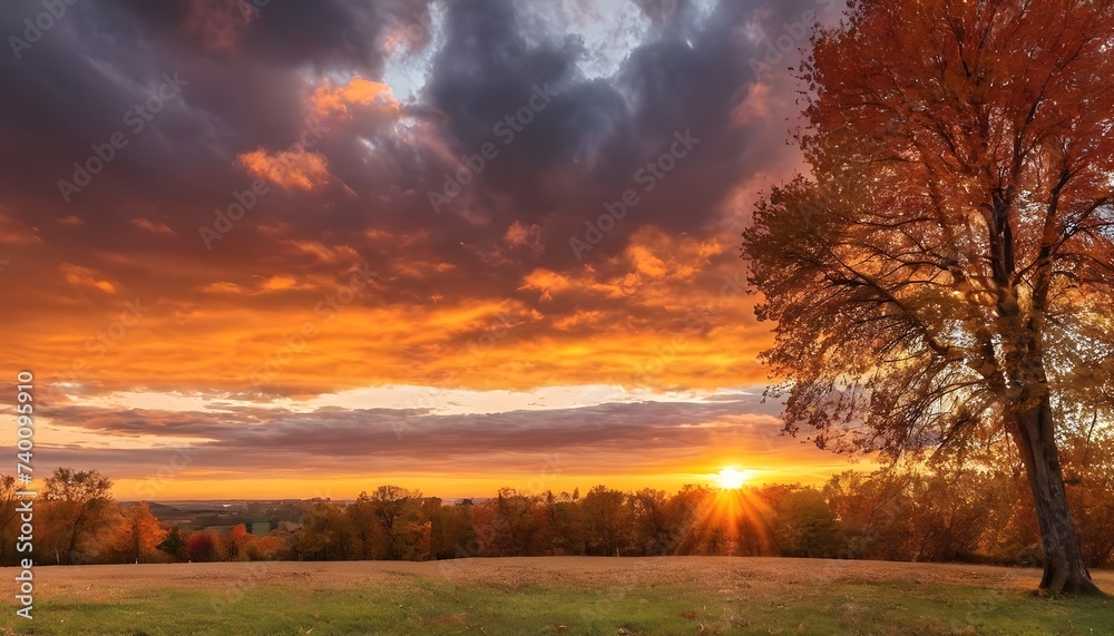 Colorful autumn sunset with sun rays coloring the clouds