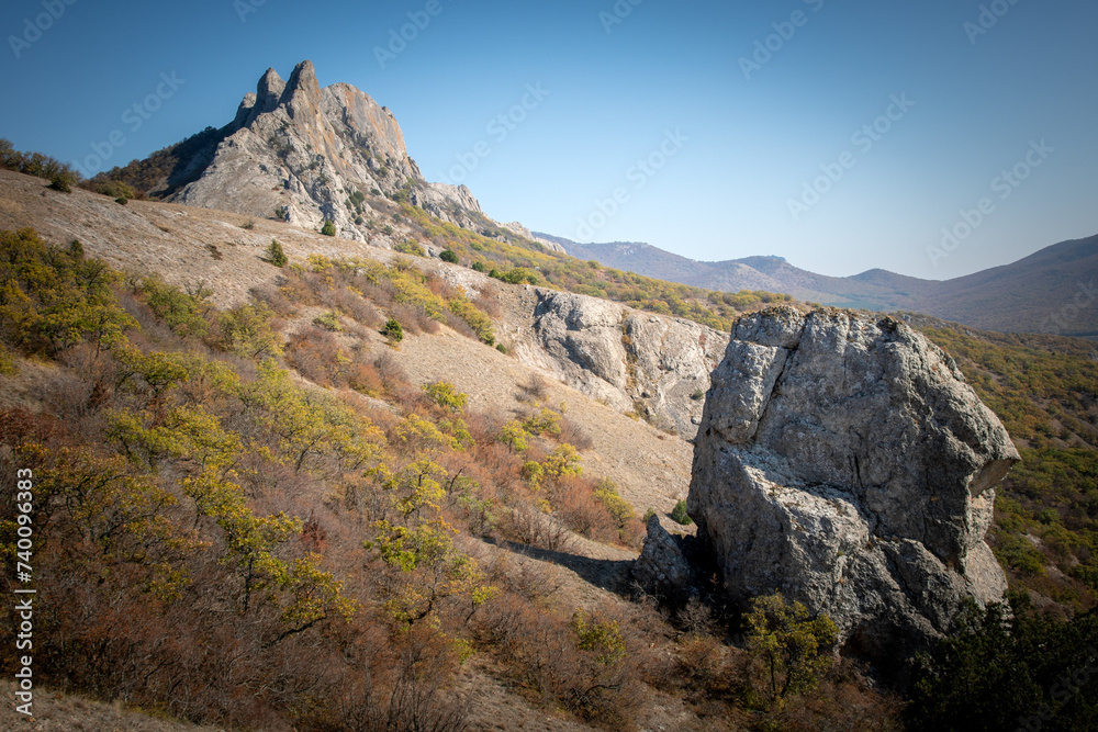Mountains and autumn forest under blue sky