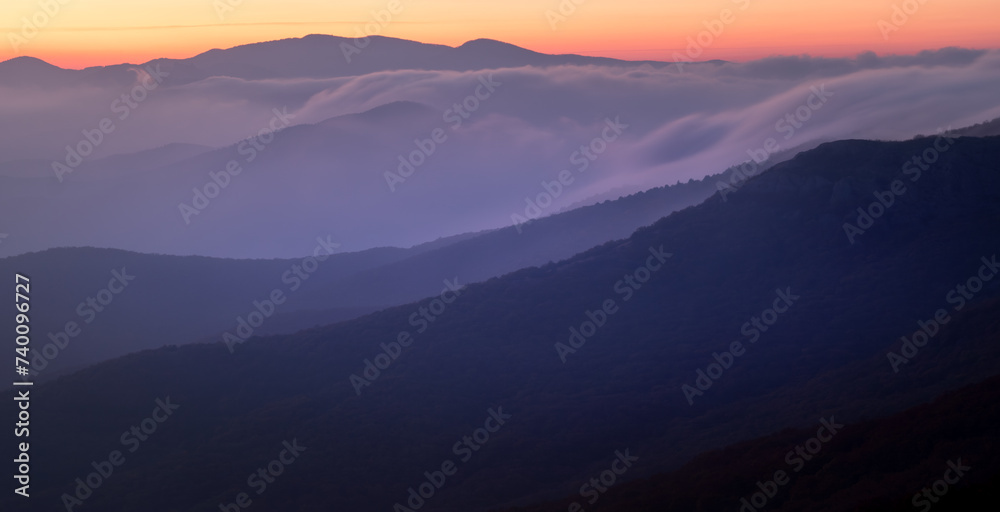 Landscape. Sunset over the mountains with clouds