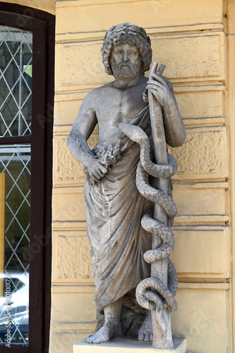 Medieval sculpture of the mythological character with a viper at the entrance to the pharmacy, Chernivtsi, Ukraine. photo