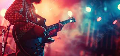 Closeup shot of a guitarist playing at a concert.