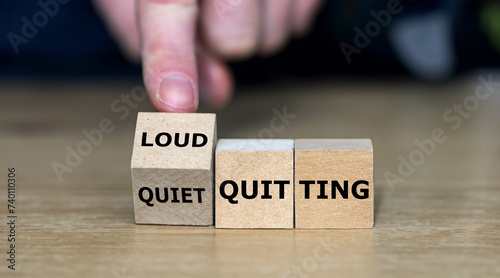 Hand turns wooden cube and changes the expression 'quiet quitting' to 'loud quitting'.
