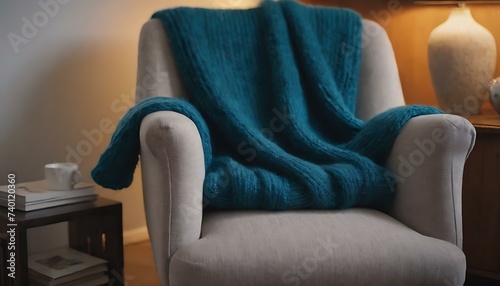 A cozy  knitted sweater draped over a chair