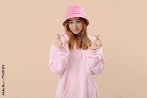 Young woman making heart wi...