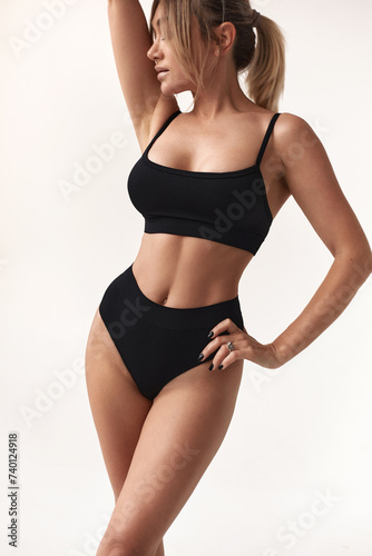 Healthy eating, sports for weight loss. Happy young blonde woman showing a perfect slim body on a white studio background, collage with outlines of an aesthetic figure