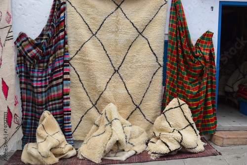 
colorful traditional Moroccan wool made blanket exposed for sale in open market.