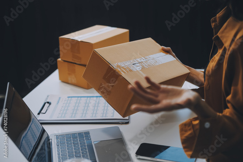 businesswoman start small business and successful SME entrepreneurs asian woman hoding boxs works from home delivering parcels online. SME delivery concept and packaging