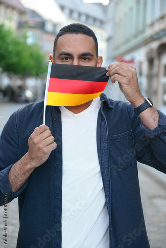 Young man with flag of Germ...