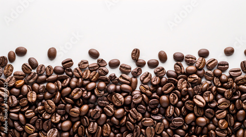 Coffee beans artfully arranged on the white background create a mesmerizing pattern with white copy space