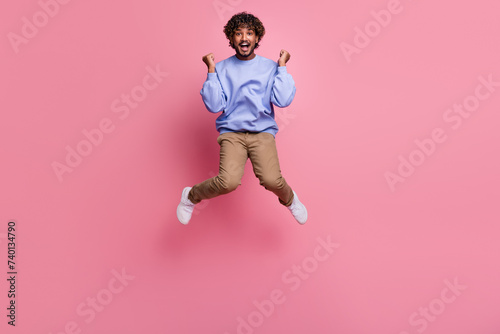 Photo of crazy cheerful nice guy dressed stylish blue clothes raise fist scream yes hooray isolated on pink color background
