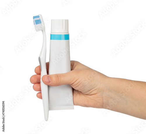 Woman's hand holding white tube of toothpaste and toothbrush © Gresei