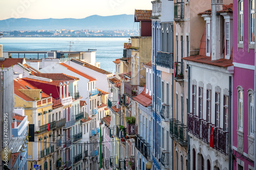 Dramatic view of colorful historic buildings in Lisbon, Portugal with the Tagus River in the background photo