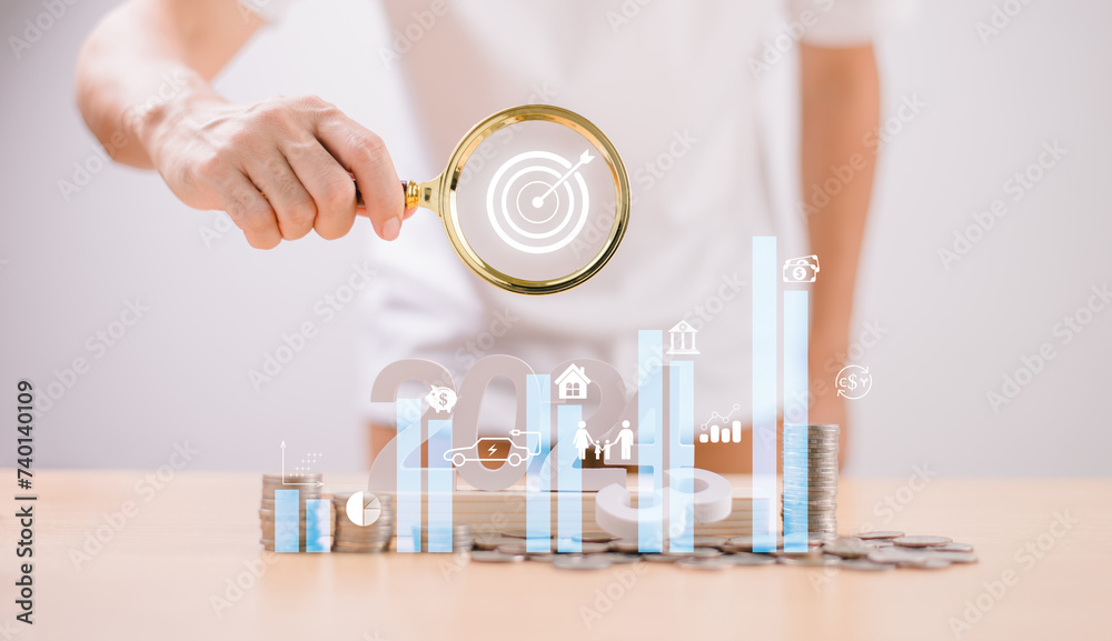 Fototapeta premium Target Goal challenge concept. Start 2024 plan Money saving, Retirement fund, Pension, Investment Financial. Businessman use magnifying glass, seo marketing. Business survival earning income profit