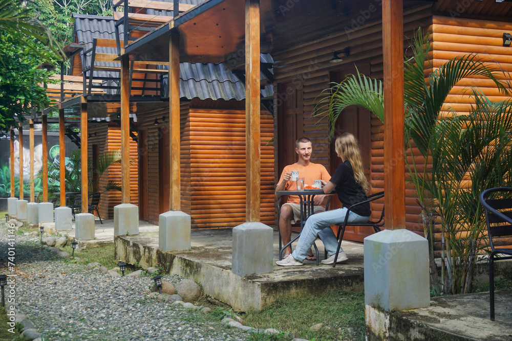 Couple having breakfast near the tiny house Couple having breakfast near the tiny house