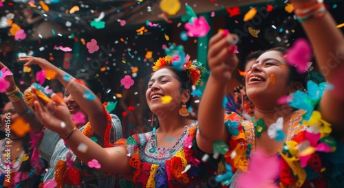 A lively group of women joyfully celebrate at a vibrant festival, their faces adorned with colorful clothing and glittering confetti as they dance in the outdoor carnival entertainment
