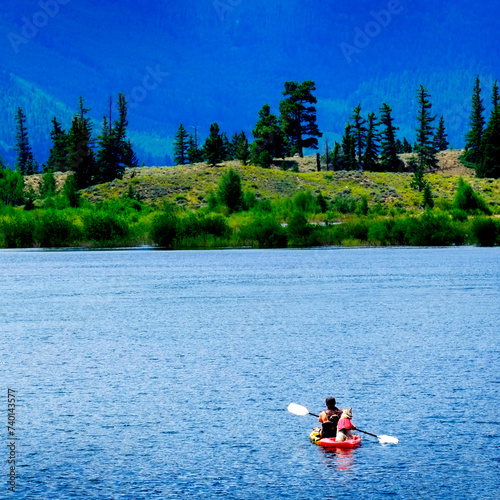 Man on Kayak on Lake Mountains Wilderness Paddling photo