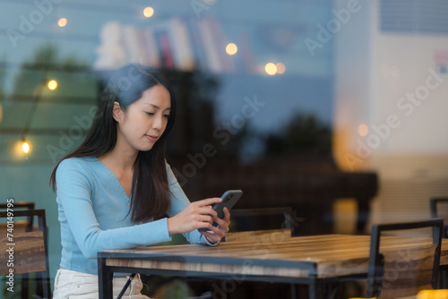 Woman use smart phone at coffee shop