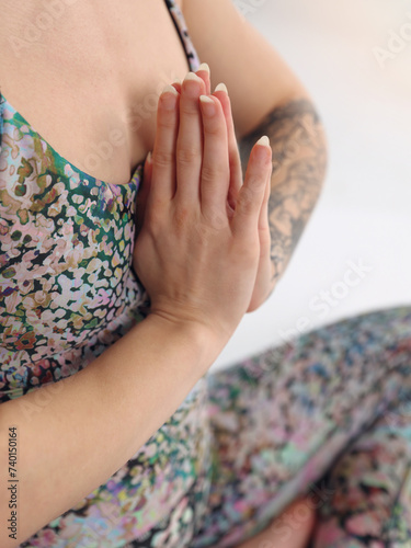 Yoga Woman Sitting in Lotus Position and with Namaste Gesture close up. Open Heart Meditation, Gratitude concept