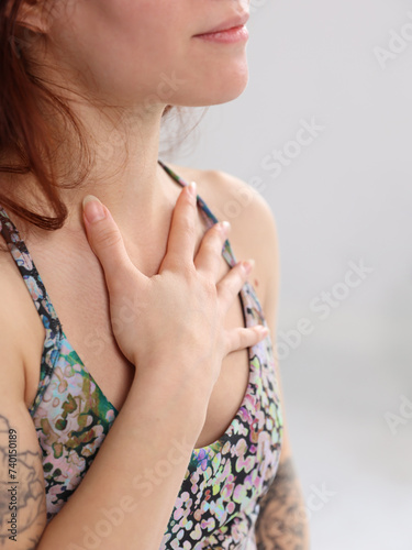 Yoga Woman Meditating, holding hand on the heart close up. Loving Kindness Meditation, Self-love , Gratitude concept photo