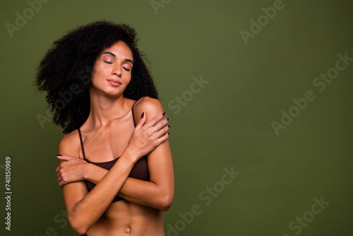 No filter studio photo of dreamy tender woman wear lingerie cuddling loving herself empty space isolated khaki color background