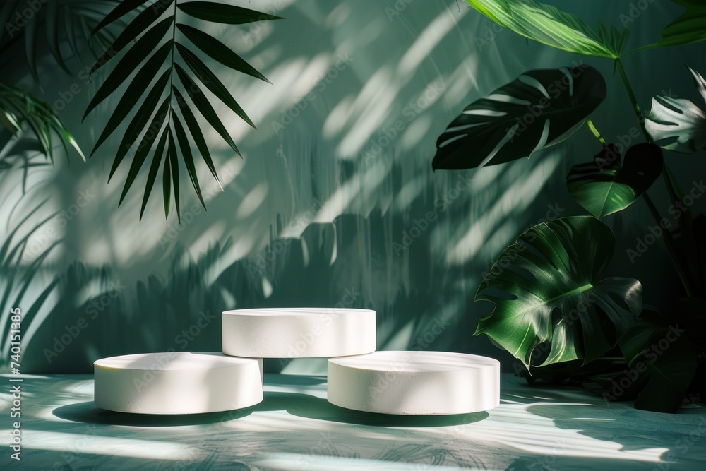 Dense tropical foliage surrounds sleek white display pedestals, casting shadows and light in a vibrant jungle-like environment.